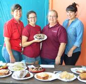 Julianna Payne's cupcakes were a big hit at the Solano County Fair. From left are Gloria Gonzalez, superintendent of McCormack Hall; Julianna Payne; Sharon Payne, assistant superintendent; and Angelica Gonzalez, staff. (Photo by Kathy Keatley Garvey).