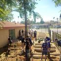 UC Riverside student volunteers, recruited by Global Food Intiative Fellow Claudia Villegas, set up new garden beds at the Community Settlement Association.
