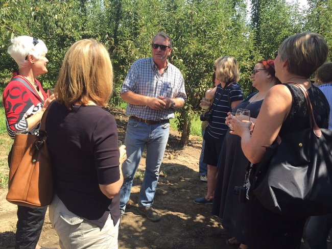 Farmer Richard Elliott, center, chats with food bloggers.