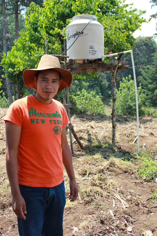 Miguel Isaias Sanchez has started farming with drip irrigation and a water tower, using information from one of the first MásRiego trainings. (Photo by Beth Mitcham)