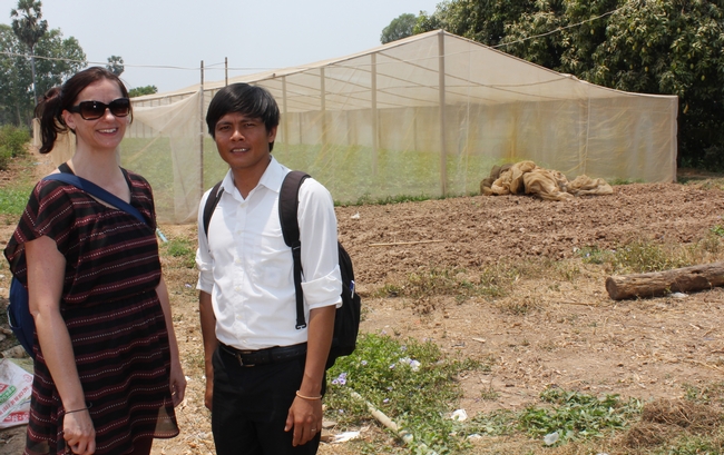 UC Davis researcher Karen LeGrand with Thort Chuong, in front of another farmer's nethouse in Cambodia built after they helped connect scientists, farmers, and marketers with technologies from the Horticulture Innovation Lab.