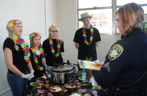 Championship Chili Five-O Team answers questions from chili judge, Detective Vicki Rister of the Rio Vista Police Department. The team (from left) Kaylee Lindgren, Madison Pitto, Hannah Crawford Stewart,  and Spencer Currey, all members of the Wolfskill 4-H Club, Dixon. (Photo by Kathy Keatley Garvey)