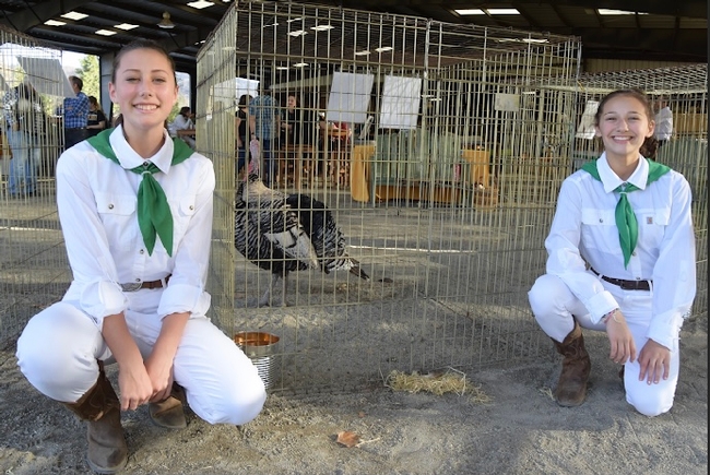 Turkey growers Brylee Aubin, left, and Yaxeli Saiz-Tapia pose at a 4-H auction event in 2018.