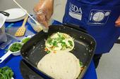 Adding green vegetables to quesadillas is a way to add nutrition to traditional staples.