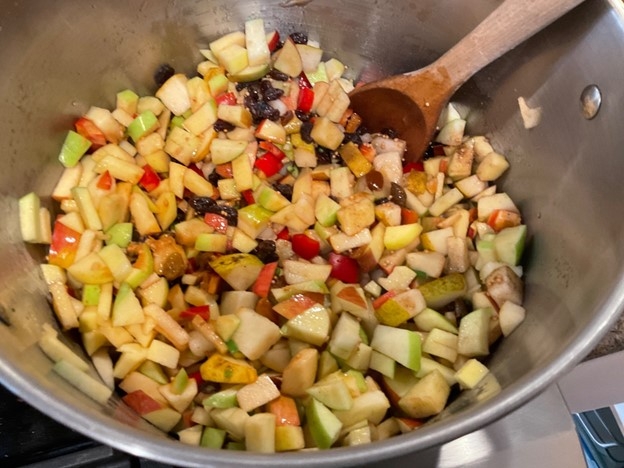 Chopped ingredients in pot with wooden spoon