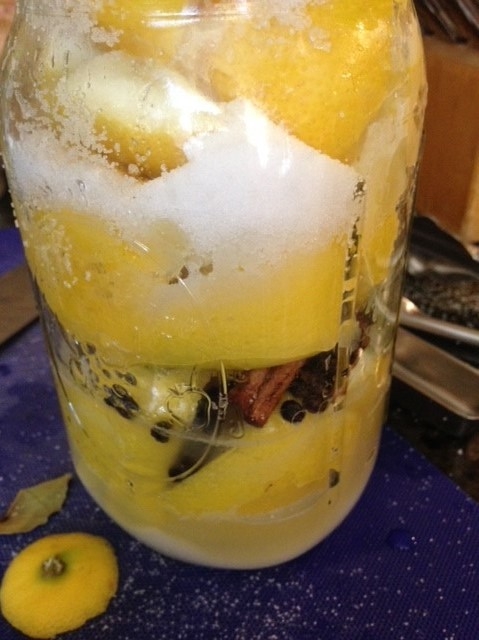 jar fully packed with lemons, salt and spices