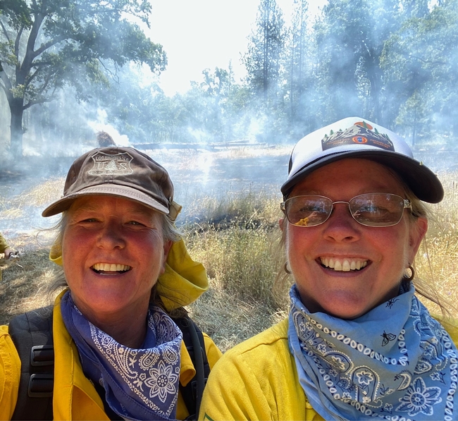 Katelman and UC ANR Forestry Advisor Susie Kocher pose for a photo during a June 2023 prescribed burn.