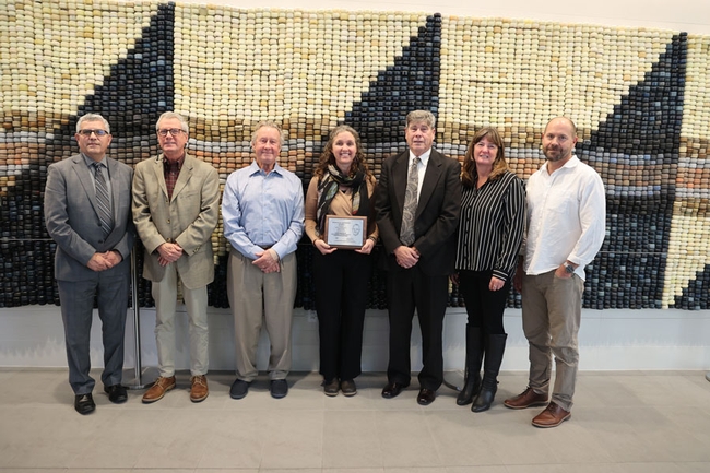 Ryan's wife, Michelle Coppoletta (center), alongside members of the Board of Forestry, accepting the award on Ryan's behalf. Credit: CALFIRE Newsroom.