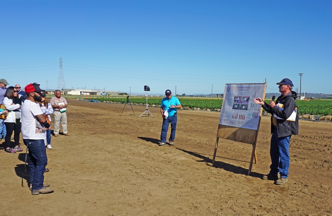 UC Cooperative Extension specialist Steve Fennimore, right, presented strawberry weed control research results. To his left, Rafael Santos provided real-time interpretation in Spanish.