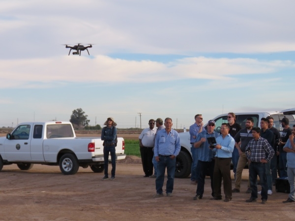 Participants at an IGIS drone workshop at Desert Research and Extension Center gain practice flying a drone.
