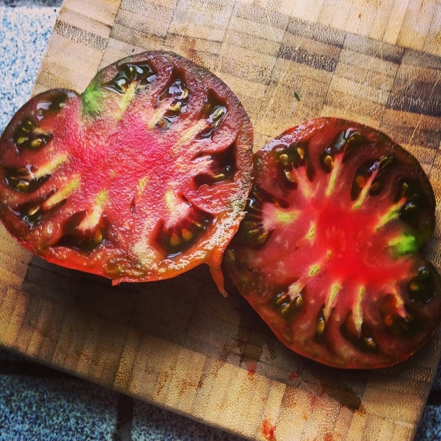 Black krim heirloom tomato from the garden mmmmmmm by xinem is licensed under CC BY 2.0.
