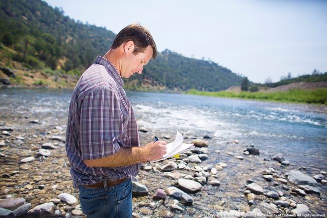 Jeremy James, SFREC Director, puts his thoughts onto paper near the river.