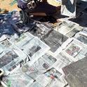 Wet newspaper atop the cardboard