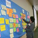 Participant Maggi Baum adds notes from her group to the statewide idea board at the statewide agritourism summit. (Photos by Brenda Dawson)