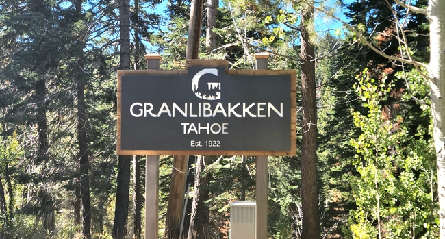 Wooden sign set in a wooded backdrop, reads Granlibakken Resort, Establisheds 1922.