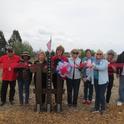 UC Master Gardener Program volunteers celebrate the opening of the 'Welcome Home Garden' alongside veteran residents of the Veterans Home of California – Ventura. Pictured left to right: Non-resident veteran (in red), trainee Iveen Garland, Trainee Marilyn Lopez, Veterans Home Coordinator Linda Griffith, trainee Marsha Meeker, volunteer lead Roanna Prell, trainee Lynn Propes, volunteer Tina Van Coops, and resident veteran Jerry.