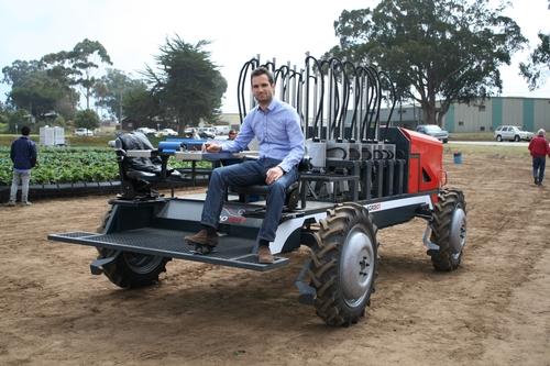 Ingeniero Juan Bravo manuvers the Agrobot out of the field.
