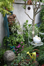 Eclectic objects can add interest to a small garden.