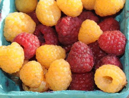 Red and yellow raspberries in a basket