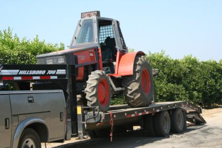 Mechanical olive pruning: Laux Management pruning machine arrives on flatbead trailer