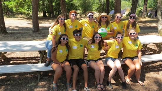 4-H camp teen counselors all in yellow shirts wearing white sunglasses