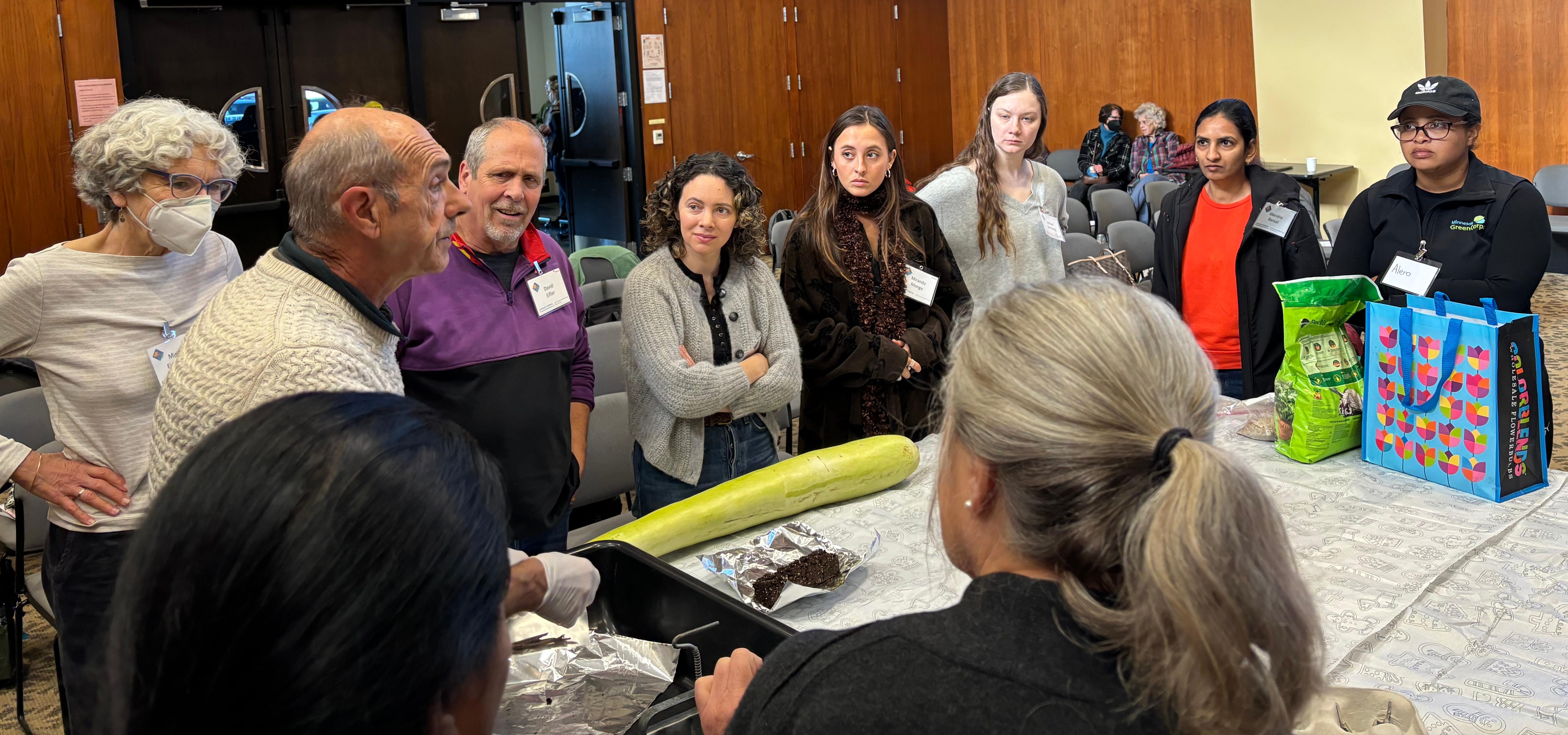 A UC Master Gardener teaching students how to transplant vegetable seedlings. Photo by: Michelle Chin (Master Gardener)