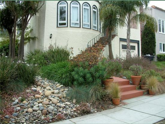 A dry creek bed gives water a chance to percolate into the soil. Photo Credit: GardenSoft