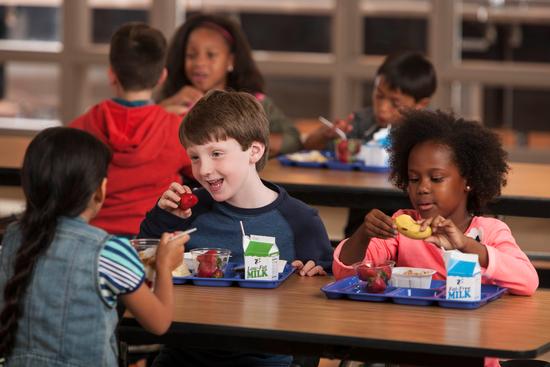 Children in cafeteria eating school meals. Photo credit: USDA.