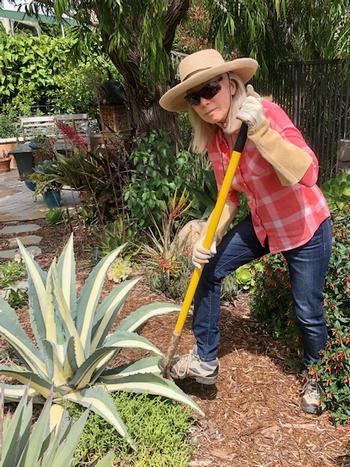 A gardener wearing rose gauntlet gloves (sleeves tucked into gloves) eye protection, long sleeves, long plants and sturdy shoes.