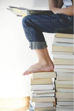Person Sitting on Books