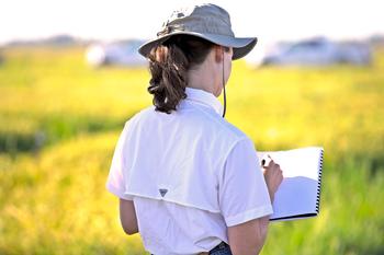 Woman taking notes in field