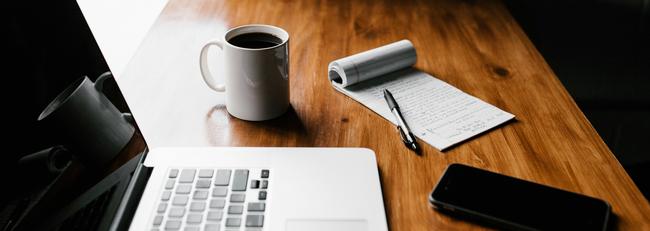 Laptop on table with coffee mug