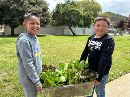 Student Leaders with a school garden lettuce harvest