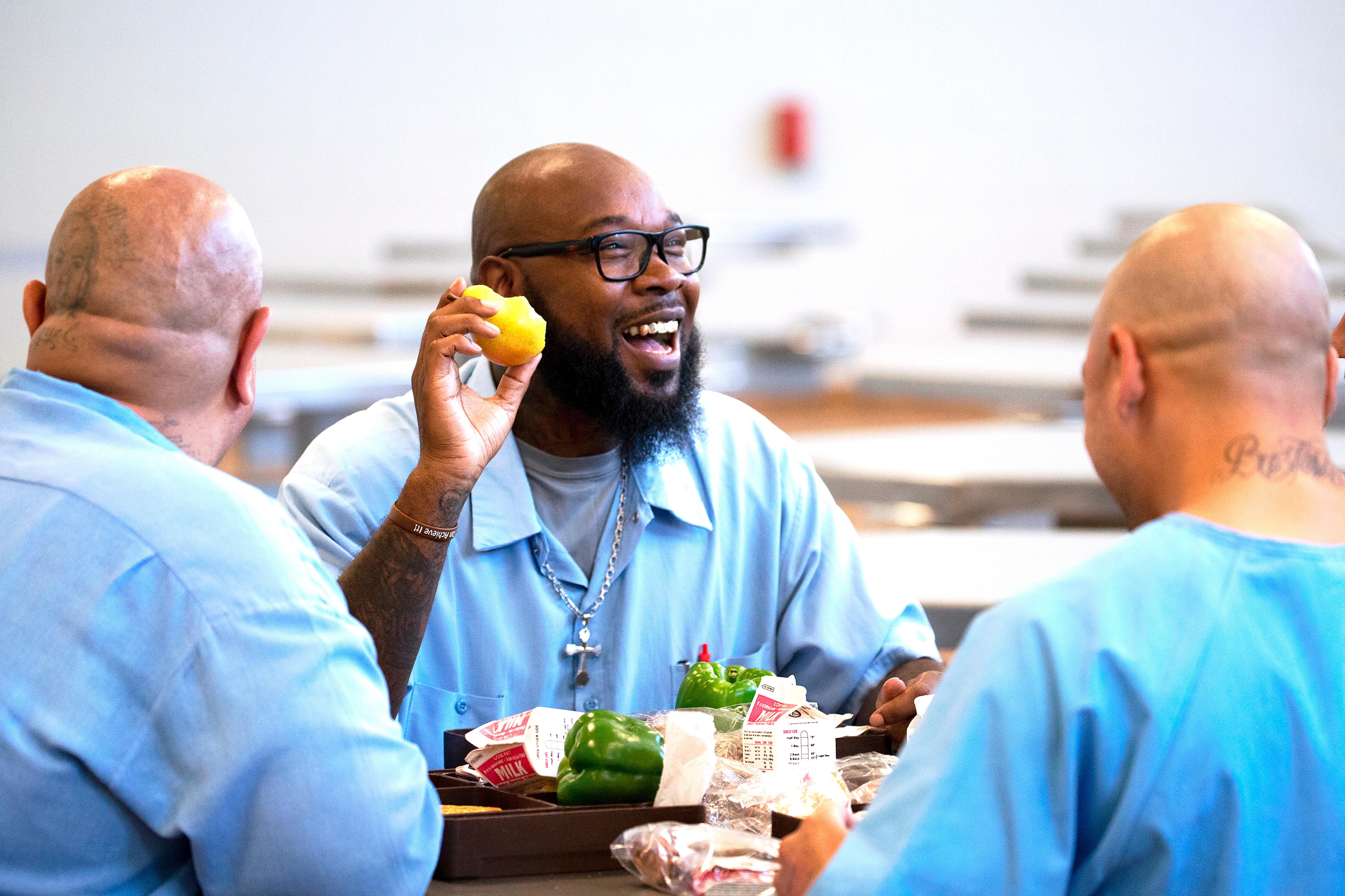 California State Prison Solano resident Patrick Range eating a local Bartlett pear. Photo credit: Evett Killmartin.