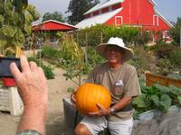 Master Gardener Volunteer with a pumpkin at Hansen REC