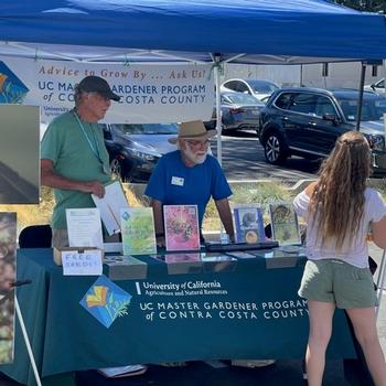 Photo by UC Master Gardener. CoCoMGs John Fike and Bill Miller volunteer at a local Farmers market.