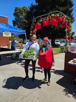 Program Coordinator Dawn Kooyumjian greets a Richmond customer at the Richmond GTPS in her very appropriate tomato costume.