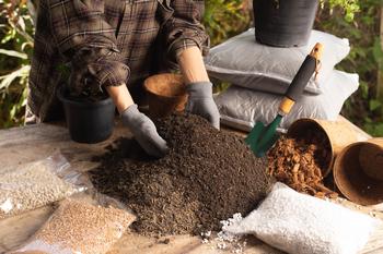 A woman builds her own potting soil. Courtesy Shutterstock.