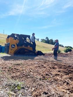 CoCoMGs Brian Kerss & Liv Imset with the tractor used to mow the hillside.