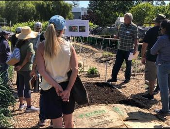 Growing Gardeners Instructor Kurt Larson leads a Vegetable Garden Irrigation class at Our Garden.  Photo by Lori Palmquist.