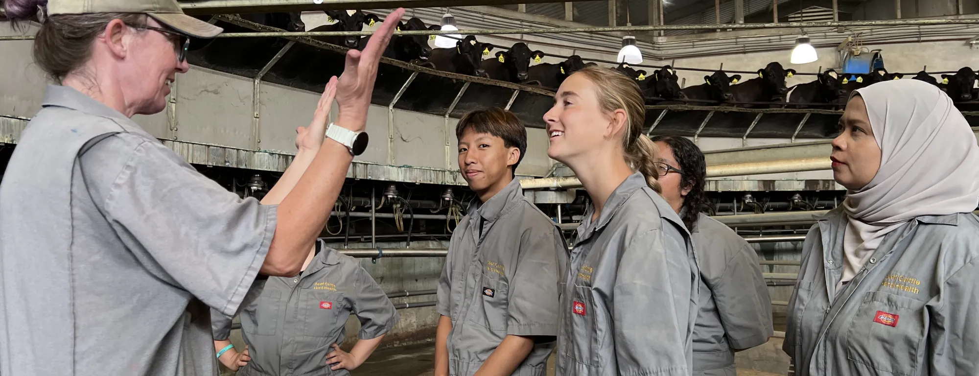 Deniece Williams, left, talks to vet med interns about rotary milking parlors