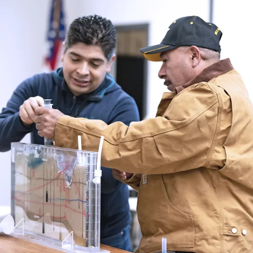 Two people participating in soil, water, and integrated pest management training at a UC Cooperative Extension site.