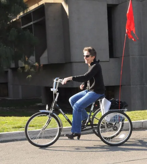 PEDALING AWAY--Birthday celebrant Lynn Kimsey, chair of the UC Davis Department of Entomology and director of the Bohart Museum of Entomology, pedals home. (A shoulder injury prompted her to temporarily trade her bicycle for this "chariot.") (Photo by Kathy Keatley Garvey)
