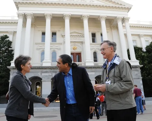 CALIFORNIA SECRETARY OF AGRICULTURE A. G. Kawamura (center) greets Lynn Kimsey, director of the Bohart Museum of Entomology and professor and vice chair of the UC Davis Department of Entomology. At right is Extension apiculturist Eric Mussen, also a member of the UC Davis entomology faculty and parliamentarian of the California State Beekeepers' Association. (Photo by Kathy Keatley Garvey)