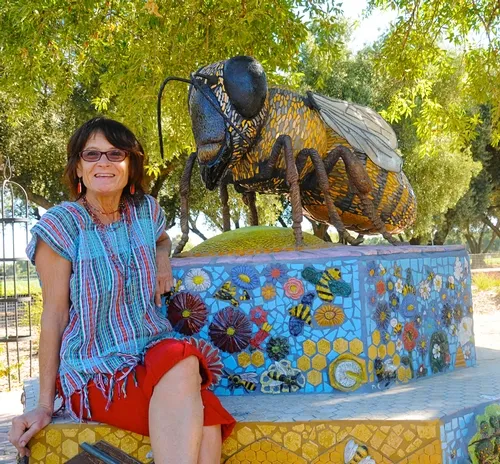 SELF-DESCRIBED rock artist Donna Billick with her sculpture, "Miss Bee Haven," at the Häagen-Dazs Honey Bee Haven at the Harry H. Laidlaw Jr. Honey Bee Research Facility, UC Davis. (Photo by Kathy Keatley Garvey)