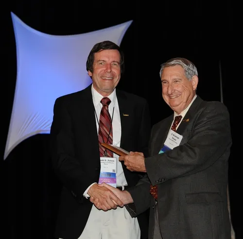 FRANK ZALOM (left), professor and integrated pest management (IPM) with the UC Davis Department of Entomology, receives the "Award for Excellence in IPM" from Entomological Foundation president S. Bradleigh Vinson, professor at Texas A&M. The award, presented at the Entomological Society of America's 58th annual meeting, held in San Diego, was sponsored by the Entomological Foundation and Syngenta Crop Protection. (Photo by Kathy Keatley Garvey)