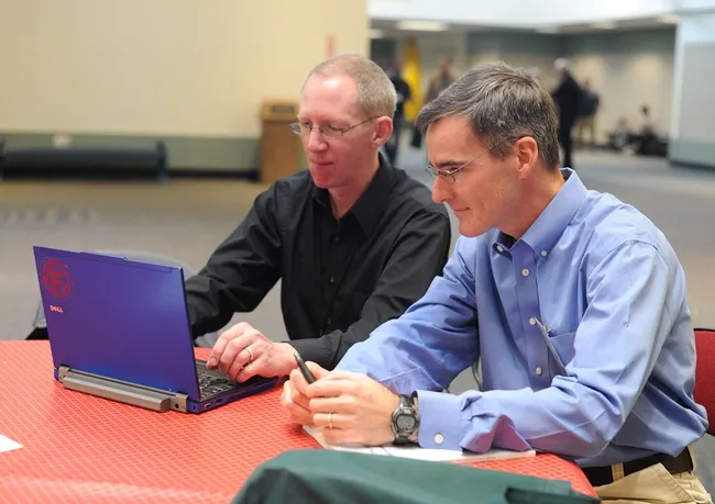 Neal Williams (right) and colleague Rufus Isaacs co confer at the Entomological Society of America meeting Wednesday, Nov. 16 in Reno. (Photo by Kathy Keatley Garvey)