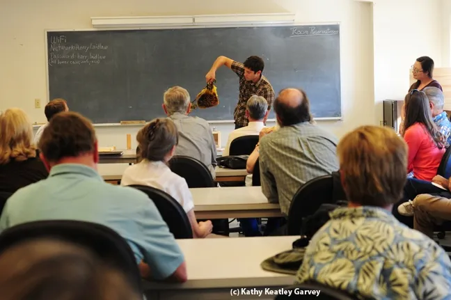 Billy Synk, manager of the Ladilaw facility, shows comb to the crowd in the Laidlaw conference room. (Photo by Kathy Keatley Garvey