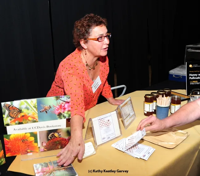 Amina Harris, executive director of the UC Davis Honey and Pollination Center, displayed honey and note cards at the UC Davis College of Agricultural and Environmental Sciences' 25th annual College Celebration. The photos on the note cards were donated by Kathy Keatley Garvey