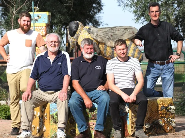 The Australian trio and two UC Davis scientists are in front of "Miss Bee Haven," the ceramic mosaic sculpture in the UC Davis honey bee garden. From left are Trevor's nephew, Reece; UC Davis native pollinator specialist Robbin Thorp, emeritus professor of entomology at UC Davis; Trevor Monson and his son, Jonathan, and in back, pollination ecologist Neal Williams, associate professor of entomology at UC Davis. (Photo by Kathy Keatley Garvey)